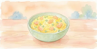 A plate of yellow rice with chicken pieces and peas, on a wooden table.